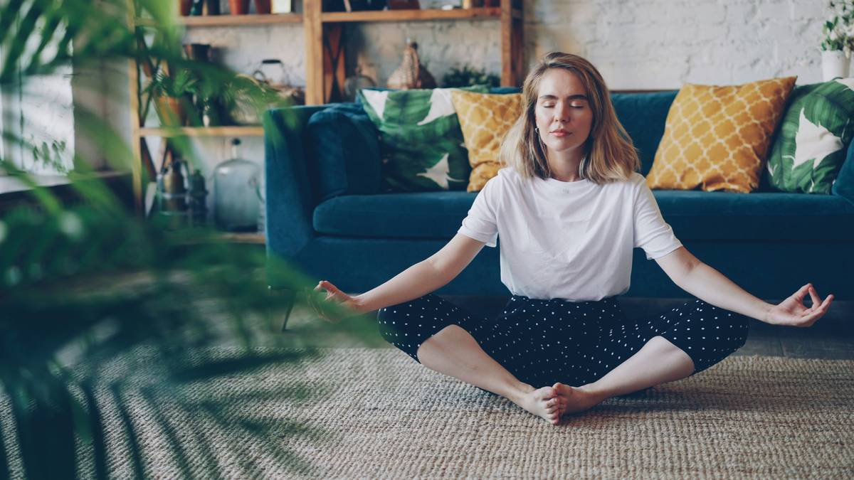 Woman practicing deep breathing at her desk as a practical stress management technique